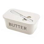 Beige butter dish with a lid on a white background