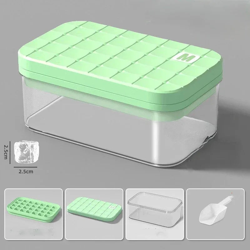 Green silicone ice cube tray with clear container on a gray background