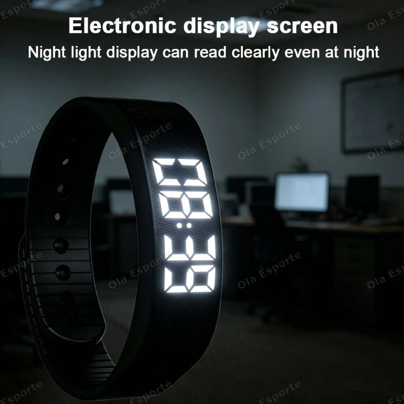 A black smartwatch band with a glowing white digital LED display, shown in a dim office-like environment with text at the top reading 'Electronic display screen' and 'Night light display can read clearly even at night'.