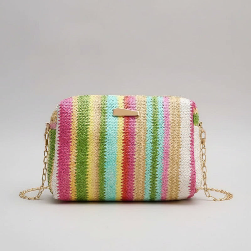 Multicolored striped handbag with a chain strap on a beige background