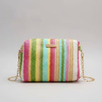 Multicolored striped handbag with a chain strap on a beige background