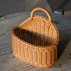 Wicker basket with a handle on a wooden surface