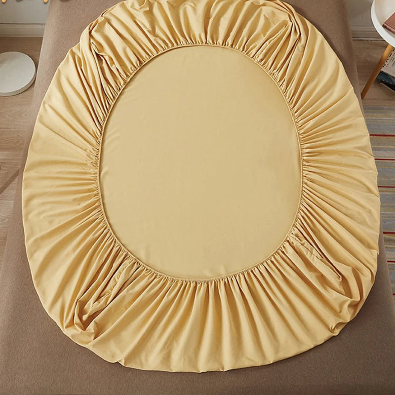 Yellow fitted sheet on a bed with 'vave' branding.