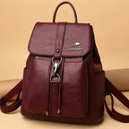Maroon backpack with a visible brand logo on a beige background