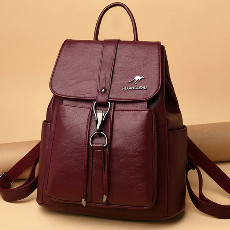 Maroon backpack with a visible brand logo on a beige background