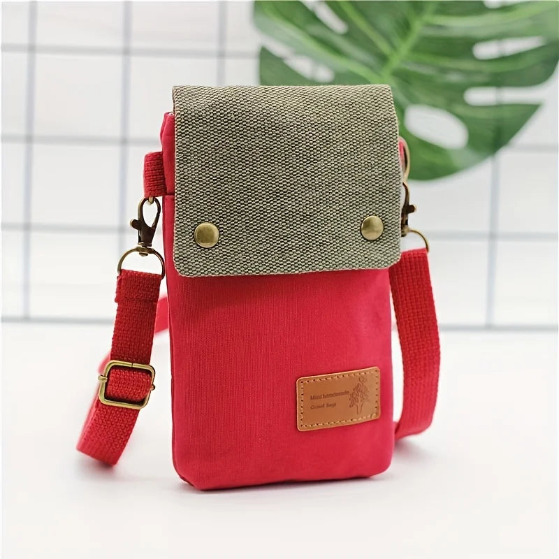 Red crossbody bag with beige top section on a white background