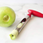Apple corer with a green apple on a white background, labeled as 'The Perfect Coring Tool'.