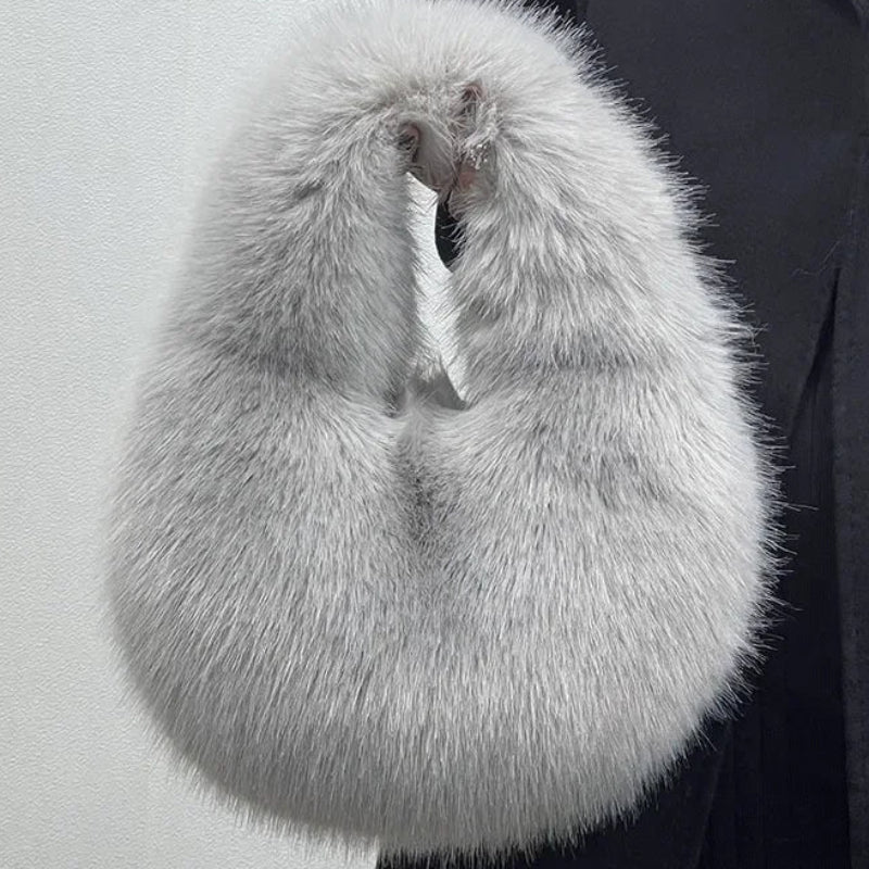 Gray fur stole held by a person against a light gray background