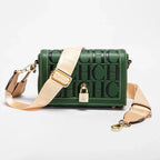 Green handbag with beige strap and gold lock on a white background