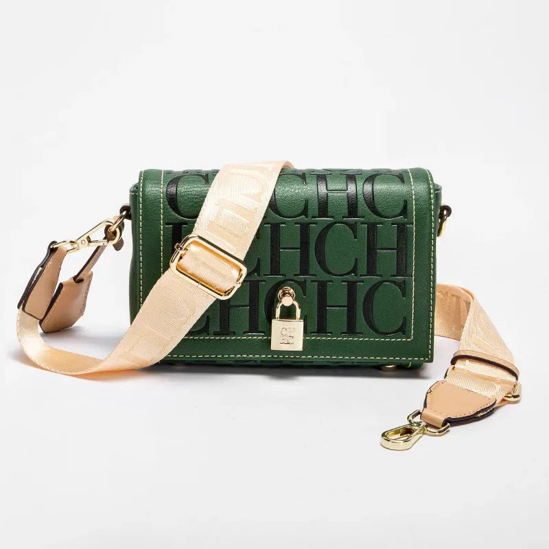 Green handbag with beige strap and gold lock on a white background