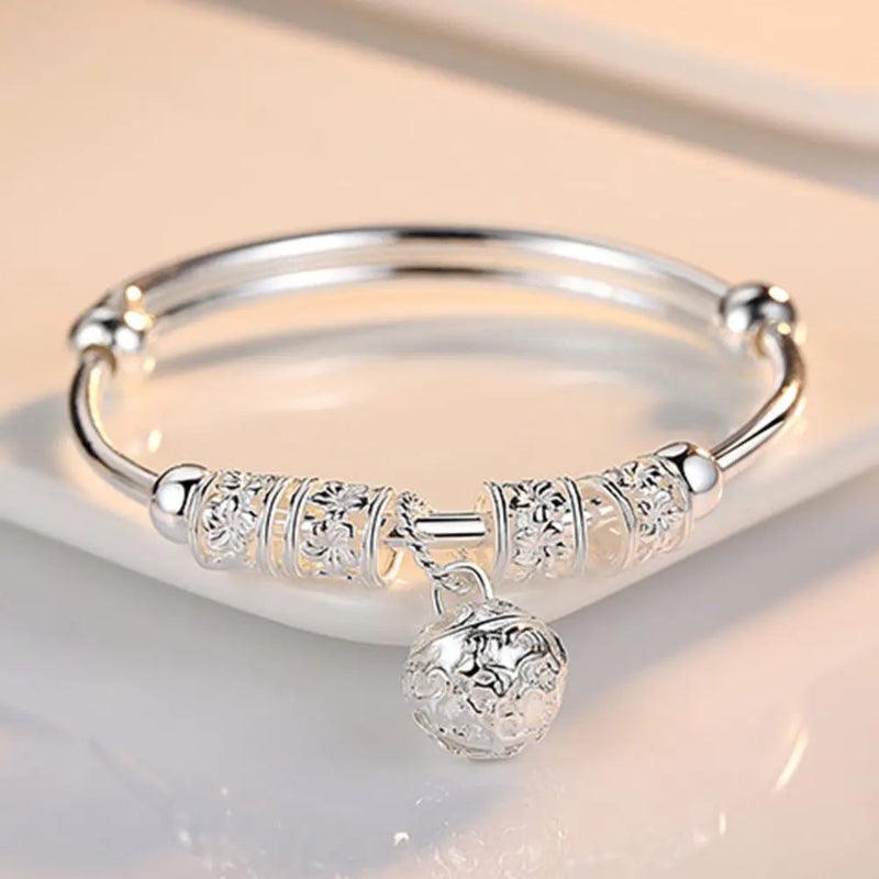 Silver bracelet with decorative elements on a light background