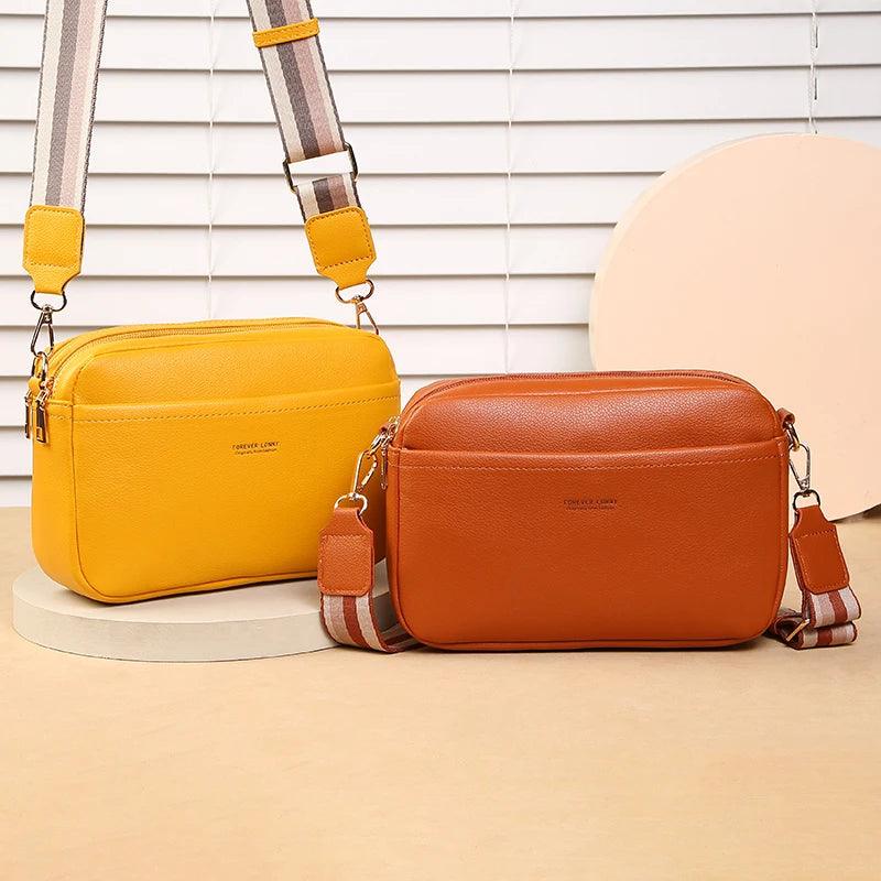Yellow and brown leather handbags on a beige surface with a neutral background