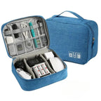 Blue travel organizer with electronic devices inside on a white background