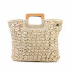 Beige woven handbag with wooden handle on a white background