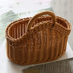 Wicker basket with a handle on a light surface