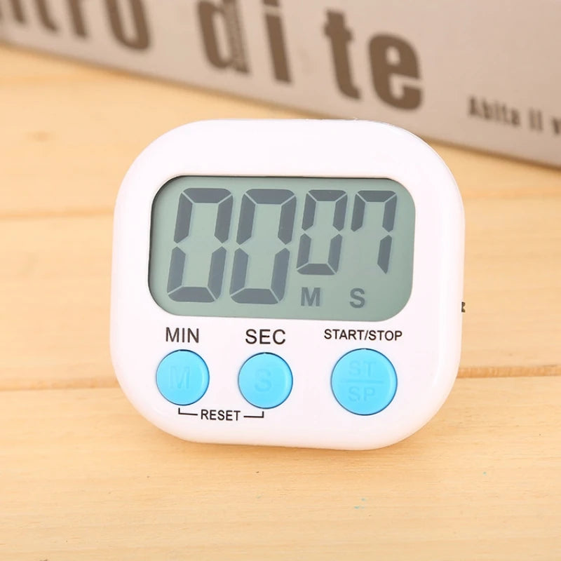 Digital timer with a white casing on a wooden surface