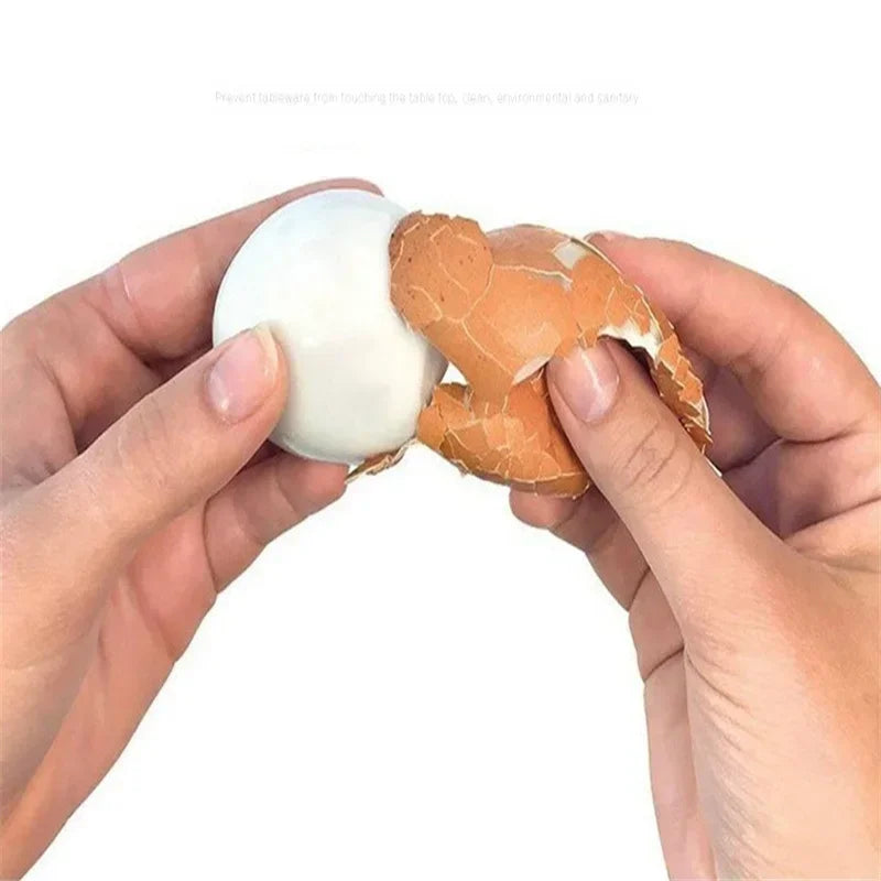 Person peeling a hard-boiled egg with a shell removal tool on a white background