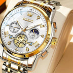 Gold and silver watch with detailed face on a beige background, featuring OLEVS branding.