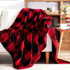 A red and black buffalo plaid fleece throw blanket is draped over a white armchair in a cozy living room setting.