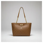 Brown patterned handbag with gold chain strap hanging on a white door handle.