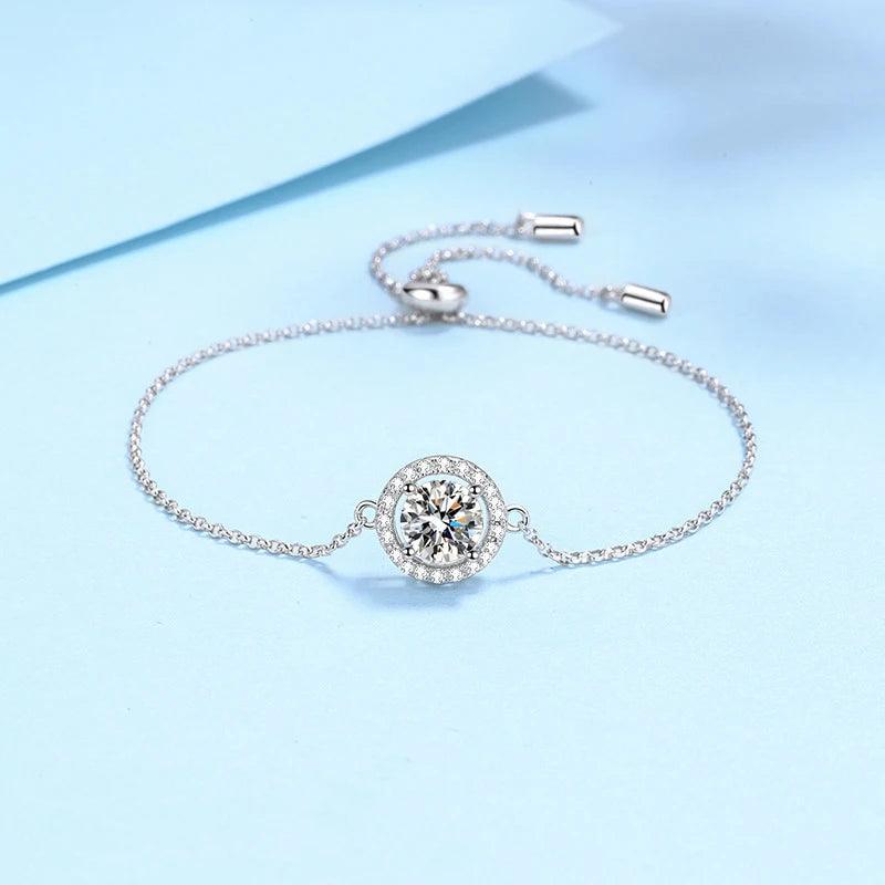 Silver bracelet with a diamond on a light blue background