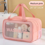 Pink washbag with transparent window on a bathroom counter