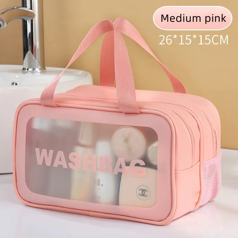Pink washbag with transparent window on a bathroom counter