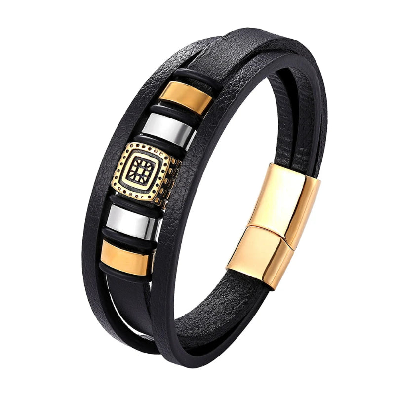 Black leather bracelet with gold and silver accents on a white background
