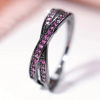 Silver ring with pink gemstones on a blurred background