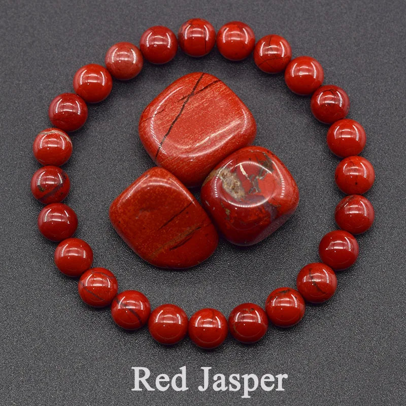 Red Jasper stones surrounded by red beads on a gray background