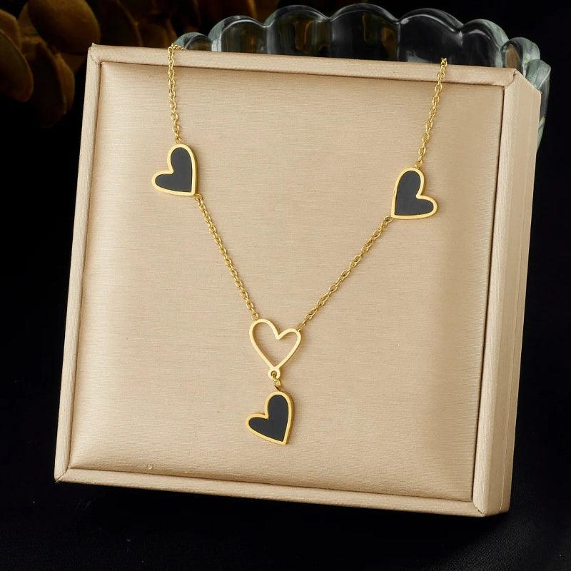 Necklace with heart-shaped pendants on a beige display box