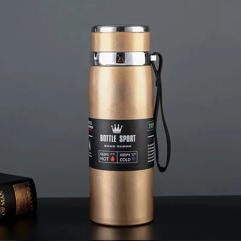 Gold insulated bottle with a black label on a dark background