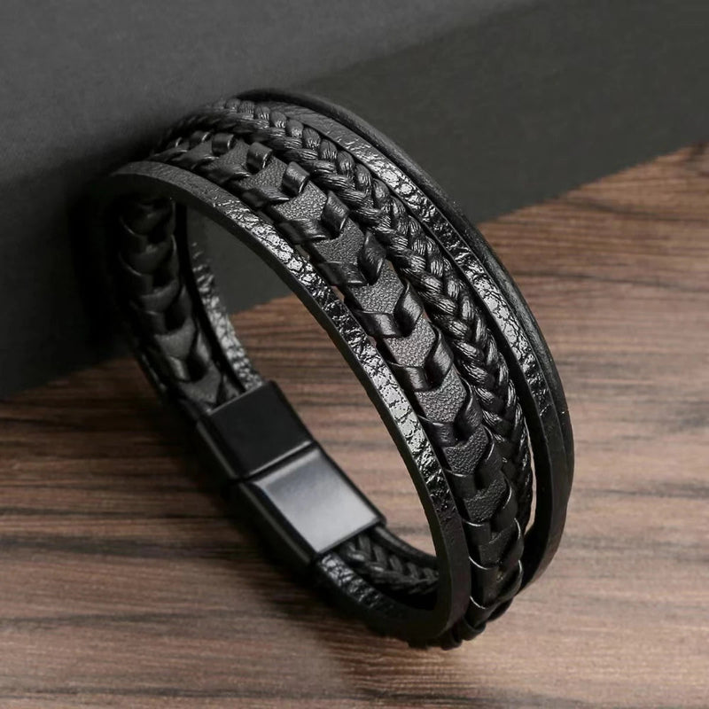 Black braided leather bracelet on a wooden surface