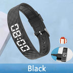 Black digital watch strap with charging cable on a light blue background