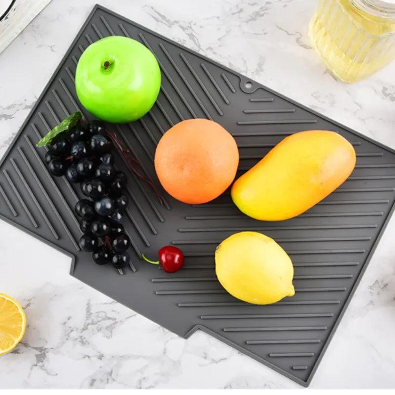 Fruits on a textured gray mat on a marble countertop