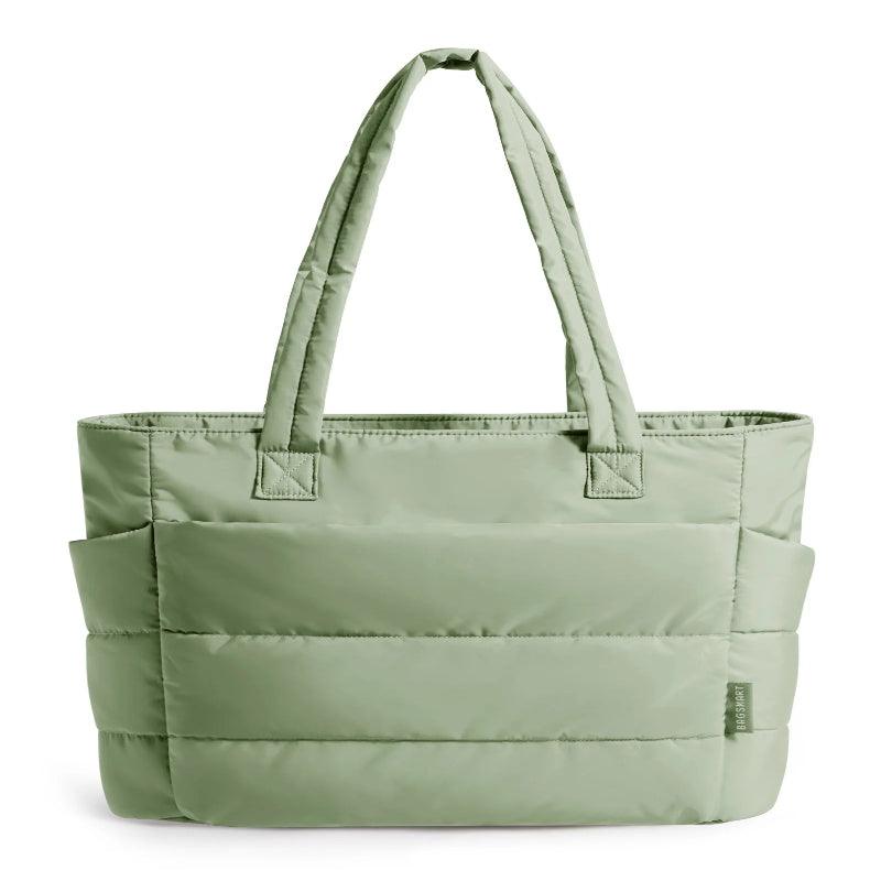 Green tote bag with multiple pockets on a white background