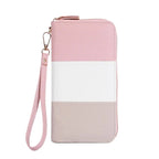 Pink, white, and beige wallet with a wrist strap on a white background