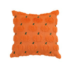 An orange textured throw pillow featuring a 3D pumpkin pattern with small green stems, set against a plain white background.
