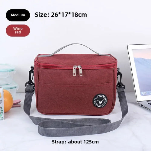 Red insulated lunch bag with gray strap on a white surface, with text indicating size and features.