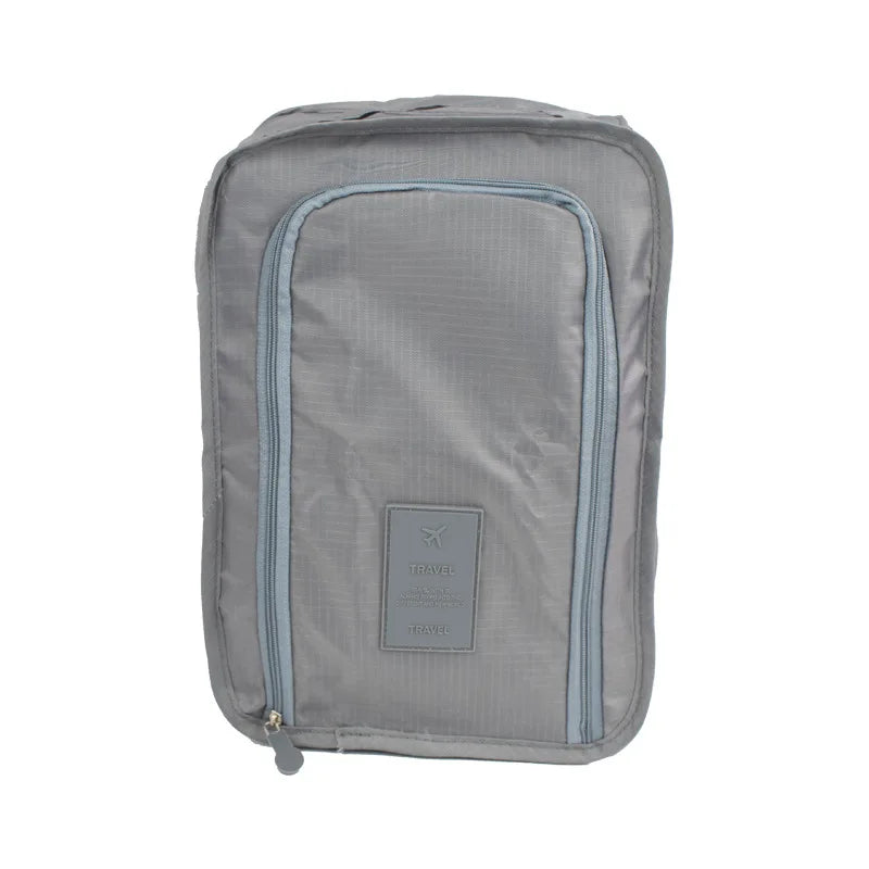 Gray travel packing cube with a visible brand label on a white background