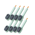 Set of 8 green cleaning brushes with gray bristles on a white background