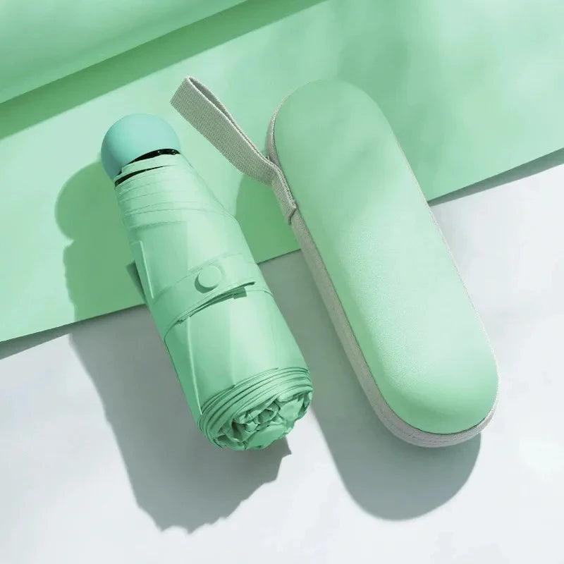 Green umbrella and its case on a light green and white background