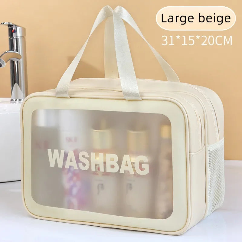 Beige washbag with transparent window showing toiletries on a beige background