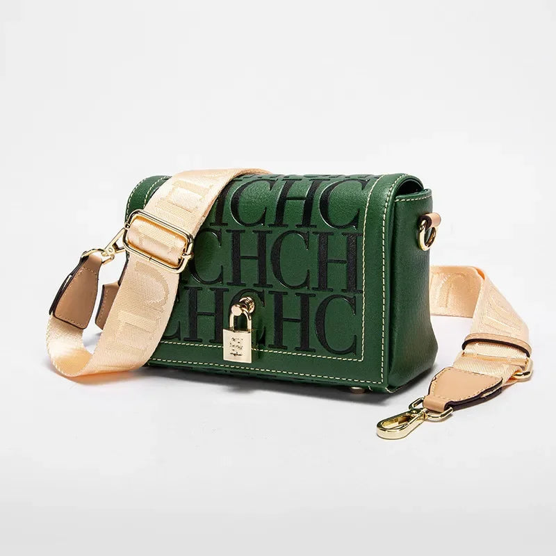 Green handbag with beige strap on a light gray background