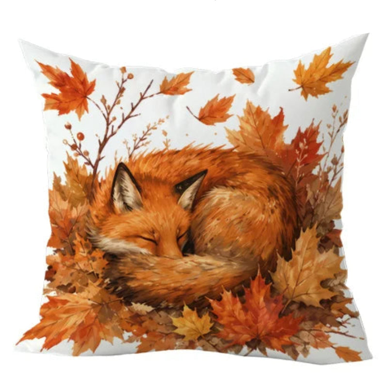 A square throw pillow featuring a printed design of a sleeping orange fox nestled among autumn maple leaves on a white background. The text 'This product is' is partially visible at the top right.