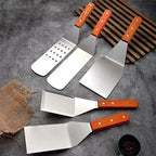 Set of metal spatulas with wooden handles on a gray surface