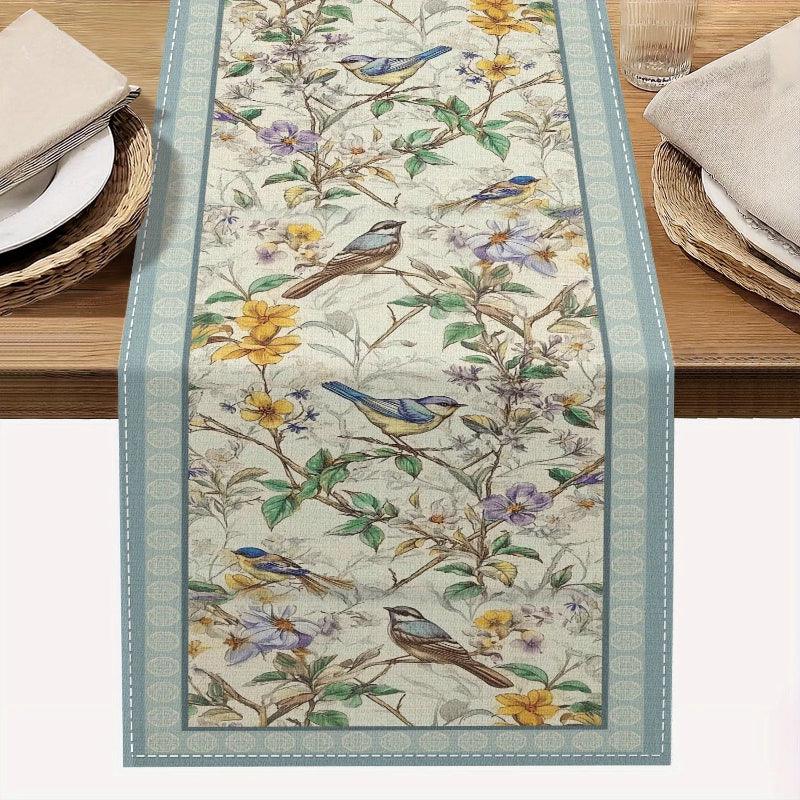 Decorative table runner with floral and bird pattern on a wooden table.