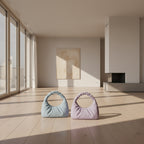 Two pastel-colored handbags on a black tray with a neutral background