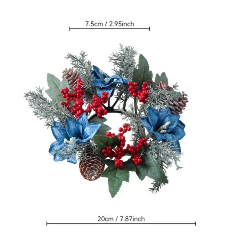 An artificial Christmas wreath with blue flowers, red berries, green leaves, and pinecones, shown with dimension lines indicating a width of 20cm (7.87 inches) and a height of 7.
