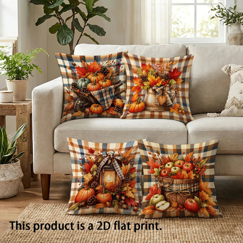 Four decorative throw pillows with a fall harvest and autumn plaid design are arranged on a beige sofa in a living room setting. The pillows feature colorful prints of pumpkins, gourds, apples, pinecones, and lanterns over a tan and brown buffalo plaid background.